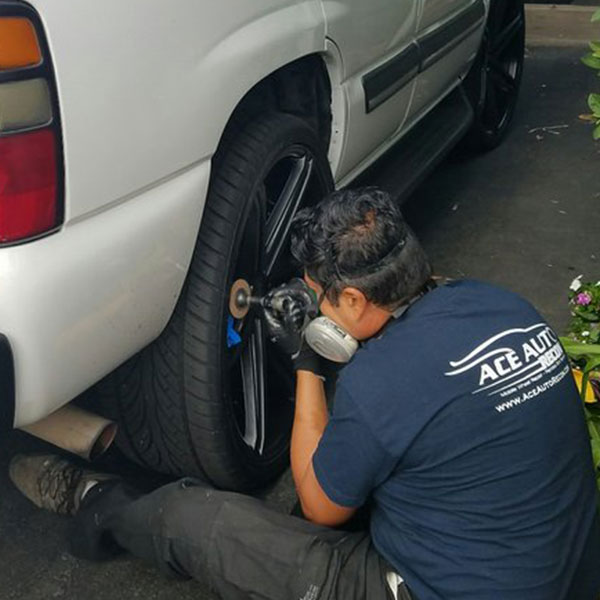 Curbed wheel being repaired at a customer's home in Los Angeles