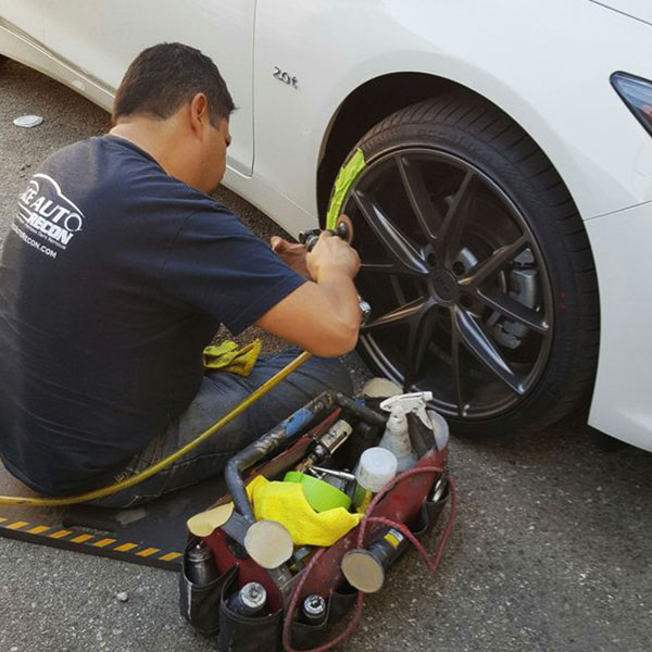 Ace Auto Recon technician repairing a curbed wheel on site in Los Angeles