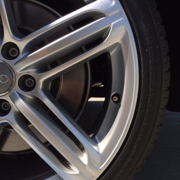 Curb rash damage on a wheel face before repair